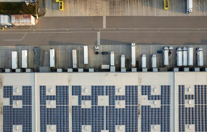 An aerial view of a parking lot with cars